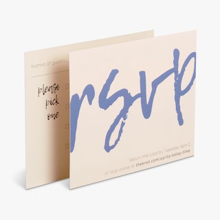 Two RSVP cards overlapping each other with rsvp in blue on the front and guest details on the back.