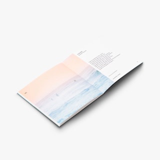 A saddle stitch booklet laying open to an ocean design in pastel orange, purple and blue and text on the right.