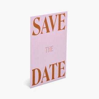 A save the date card printed with a pink background and Save The Date in dark orange.