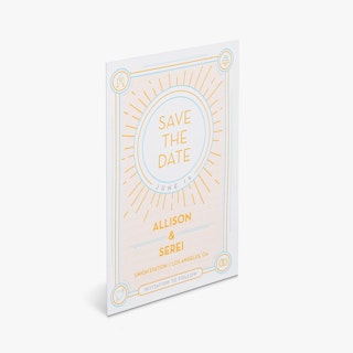 A save the date postcard printed with a yellow and blue sun design and Allison & Serei in yellow.