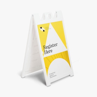 A white A-frame sign holding a sign printed in white, yellow and black with school registration details.
