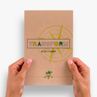 Two hands holding a customized brochure printed on Kraft paper with Transform Kids Camp on the cover.