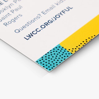 The bottom corner of a school direct mail postcard printed with an email address and design in teal and yellow.