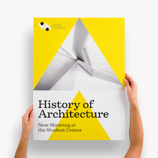 Two hands holding a foam board sign printed with History of Architecture in black, white and yellow.