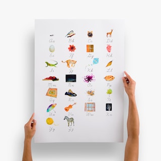 Two hands holding a large poster printed with alphabet letters and matching illustrations above them.