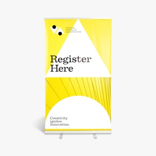 A pop up banner printed in white and yellow with Register Here and Creativity Ignites Innovation in black.