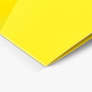 The bottom of a custom booklet printed with a saddle stitched binding and yellow cover.