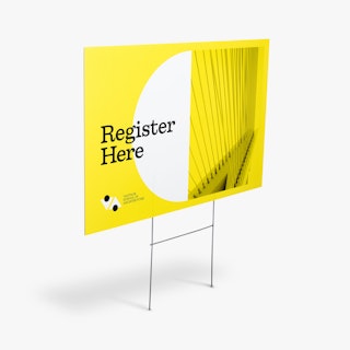A school yard sign printed with a yellow and white design and Register Here in black.