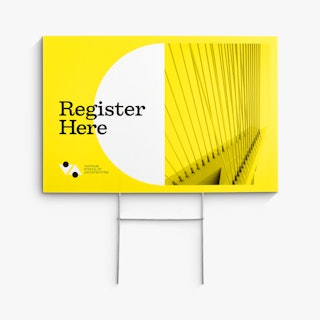 A custom lawn sign printed with Register Here and Vantage School of Architecture in yellow, white and black.