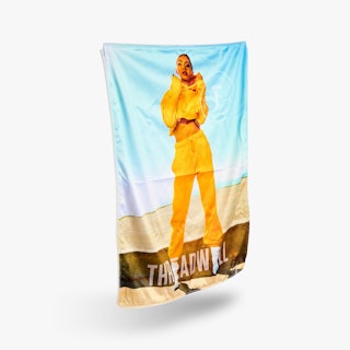 SEG fabric printed with a woman wearing a yellow outfit and Threadwell along the bottom.