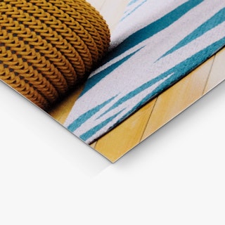 The bottom corner of a sell sheet printed with an image of a rug and brown woven basket.