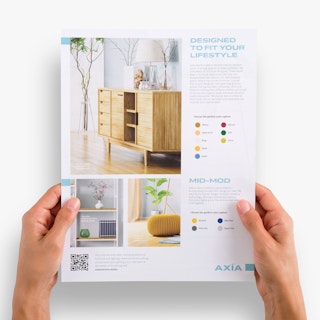 Two hands holding a sell sheet printed with images of and details for furniture.
