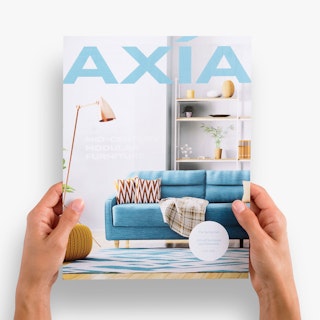 Two hands holding a one sheet printed with Axia in blue and an image of a living room.