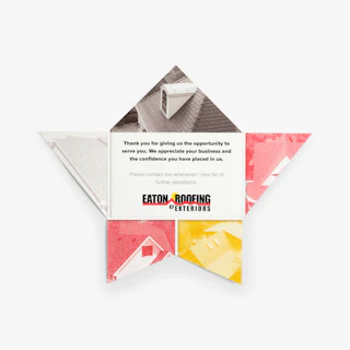 A star folded cross brochure laying flat with five sharp panels printed in red, yellow and gray.