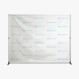 A step and repeat backdrop with a business name and logo in blue and a white background.