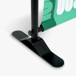 The black bottom foot of a step and repeat banner stand.