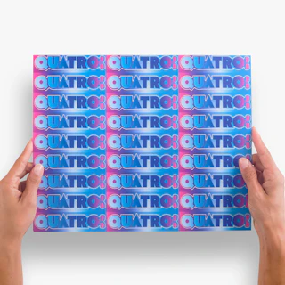 Two hands holding a sticker sheet printed with Quatro repeated in pink, blue and white.