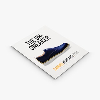 A custom styrene sign laying flat and printed with The Un-Sneaker and an image of a shoe.