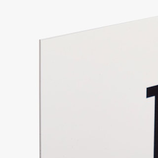The top left corner of a styrene sign printed with a solid white background and white edge.
