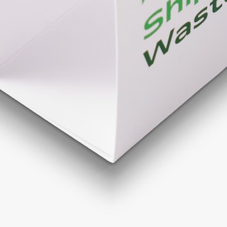 The bottom corner of a branded table tent printed with a white background and green text.