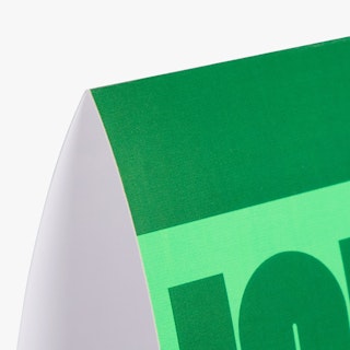 The top corner of a folded table tent custom printed in dark green and light green.