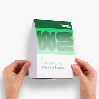 Two hands holding a personalized table tent printed in green and white with World Express in the corner.