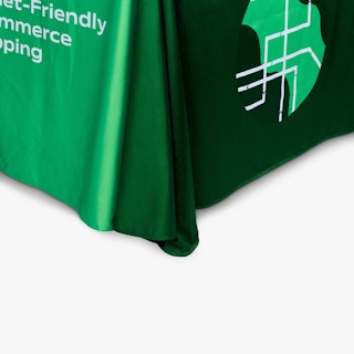 The corner of a branded tablecloth printed in shades of green and white text.