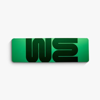 The top of a branded table throw printed with a light green background and WE in dark green.
