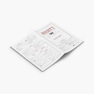 A take-out menu laying open with Biscuit's Steakhouse printed on the front and food items printed on the back.