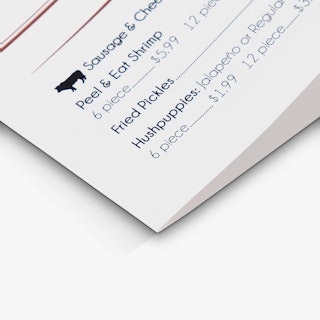 The bottom corner of a take-out menu printed with sausage, shrimp, pickle and hushpuppy details.