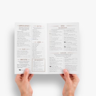 Two hands holding a custom take-out menu open to food items listed on both panels.