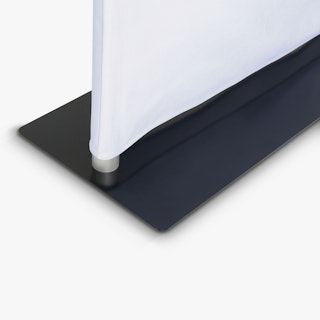 The black base of a tension fabric display with a white fabric graphic.