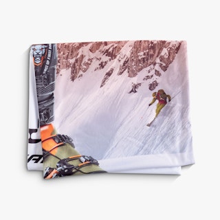 A folded printed graphic for a tension fabric display of a person skiing down a snowy mountain.
