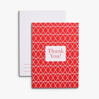 Two red and white thank you cards overlapping each other with a geometric pattern on the front.