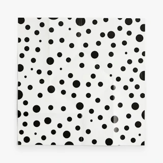 An unfolded twist brochure laying flat with a black and white polka dot pattern on the interior.