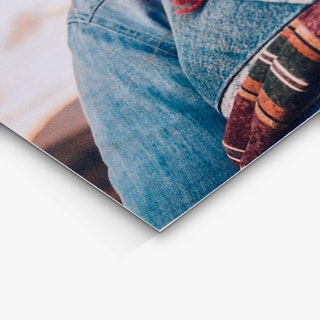 The bottom corner of a wedding invite printed with two people wearing denim jackets.