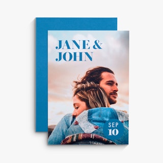 Two wedding invites overlapping each other with a blue background, Jane & John and a man and woman hugging.