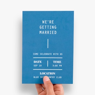 A wedding invitation custom printed with a blue background and date, time and location details in white.