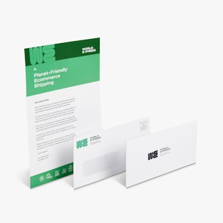 A green and white letter mailer behind a matching window envelope and reply envelope.