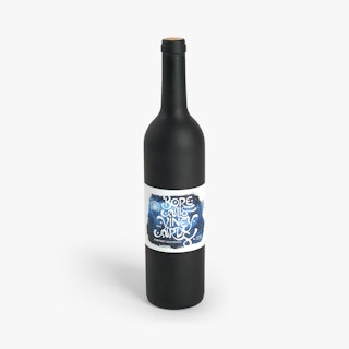 A dark wine bottle standing with a blue, black and white label printed with Borealis Vineyards.