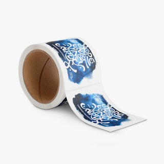 A roll of wine labels printed with a blue, black and white design and Borealis Vineyards.