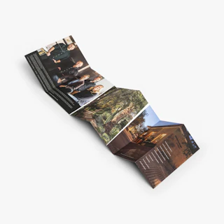 A wrapped stepped accordion brochure unfolded to images of a group of people and a home.