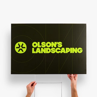 Two hands holding a branded yard sign printed with Olson's Landscaping in black and yellow.